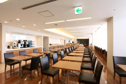 a row of tables and chairs in a restaurant at Hiroshima Tokyu REI Hotel in Hiroshima