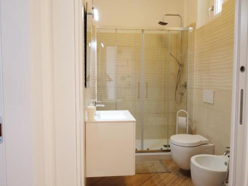 a bathroom with a toilet and a sink and a shower at IL NIDO IN CENTRO in La Spezia