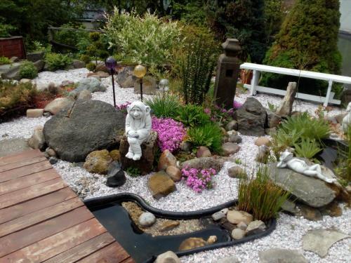 a fairy garden with a statue in the middle at Chalupa Medium in Krásná Lípa