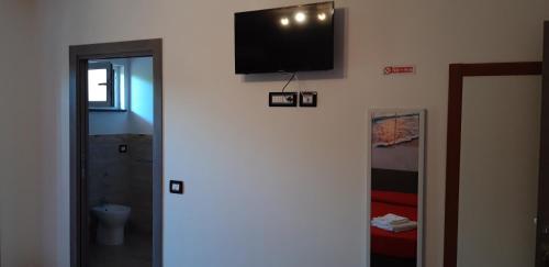 a bathroom with a flat screen tv on a wall at Valeri 's Country House in Sperlonga