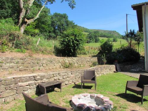 a group of chairs and a fire pit in a yard at GITE IBARLA BORDA in Bidarray