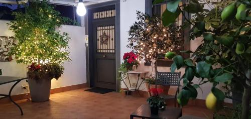 a room with potted plants and a black door at La Foresteria Garden Boutique B&B in Catania