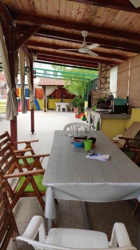 a table and chairs in a patio with a kitchen at Apartments Maja in Star Dojran