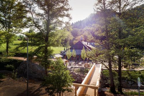 a view of a garden with a house and trees at Gästehaus der Geroldsauer Mühle in Baden-Baden
