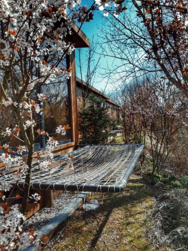 a bench sitting in the grass next to a tree at Pamera Garden Hotel in Kılıçlı
