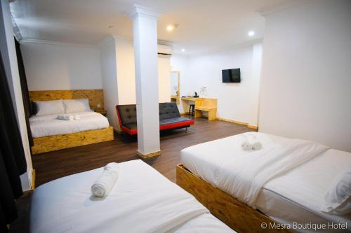 Katil atau katil-katil dalam bilik di Mesra Boutique Hotel