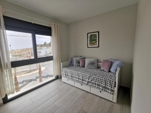 a bedroom with a bed and a large window at Penthouse Avocado with sea view in Finestrat