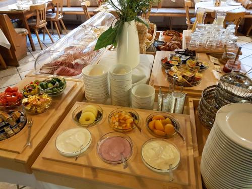 a table topped with plates and bowls of food at Gasthof Gruber in Fridolfing