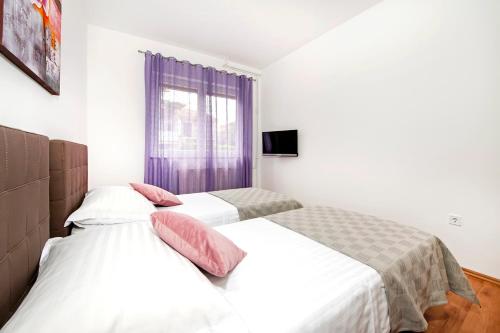 Ένα ή περισσότερα κρεβάτια σε δωμάτιο στο Apartments Euphemia