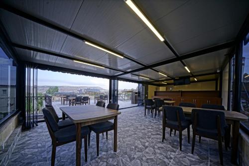 a dining room with tables and chairs and a view at Epoch Stone House in Goreme