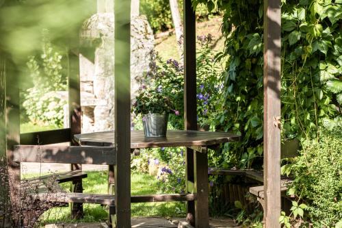 a wooden table with a potted plant on it at Belvedere Dolomites Flower Hotel in Moena