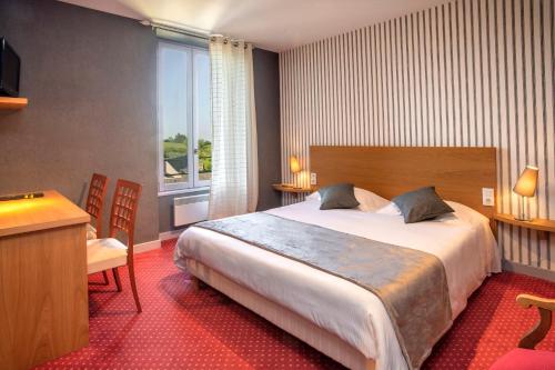 a hotel room with a large bed and a window at Logis Hôtel Restaurant Gilles Moreau Laguiole in Laguiole