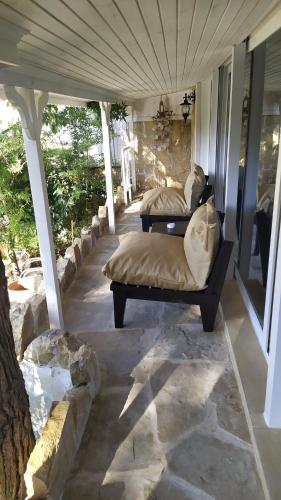 two beds on the porch of a house at Lethe Exclusive Hotel in Agva