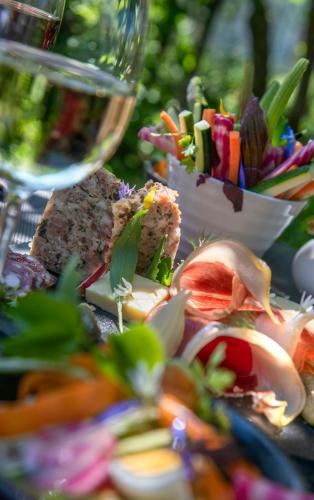 a table with a plate of food and a glass of wine at Logis Hôtel Restaurant Gilles Moreau Laguiole in Laguiole