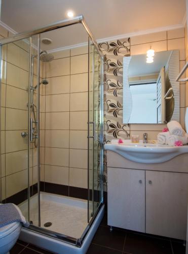 a bathroom with a shower and a sink at Kastro Beach Apartments in Malia