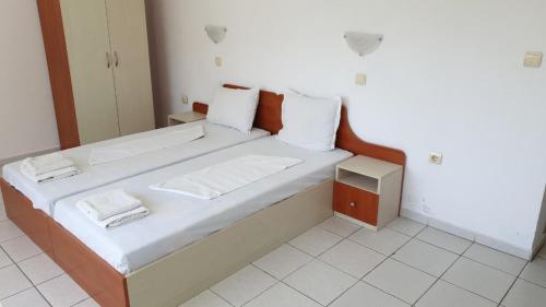 a large bed with white sheets and towels on it at Майстор Костадин - 1878 in Obzor
