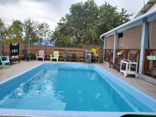 a swimming pool on the patio of a house at Villa de 4 chambres avec piscine partagee terrasse amenagee et wifi a Le Tampon in Le Tampon