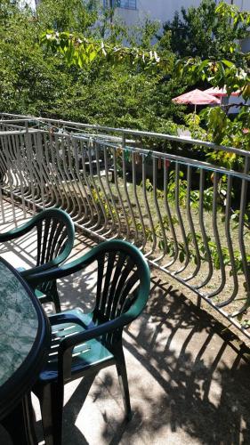 a metal bench with two chairs and a table at Майстор Костадин - 1878 in Obzor