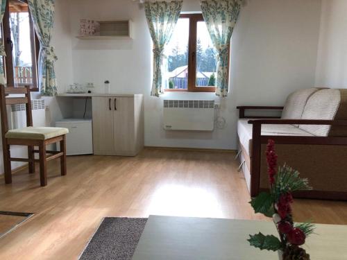 a room with a bedroom with a bed and a kitchen at Chalet Il Rifugio Bradet in Săcele