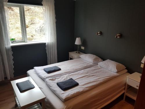 a bedroom with a large bed with two pillows on it at Efra-Sel hostel in Fludir