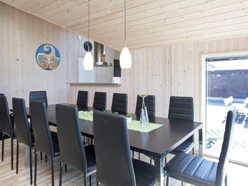 a dining room with a table and chairs at 12 person holiday home in Idestrup-By Traum in Marielyst