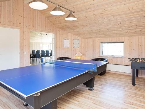 a room with a ping pong table in it at 12 person holiday home in Idestrup-By Traum in Marielyst