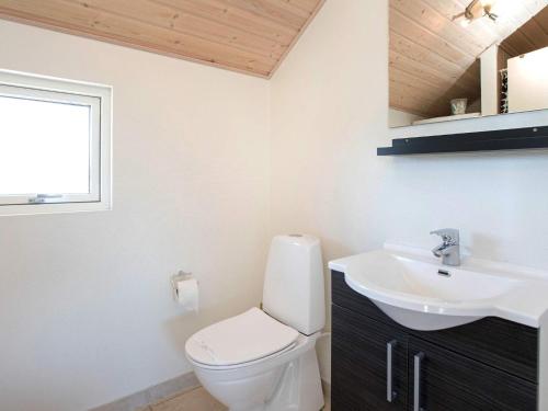 a bathroom with a toilet and a sink at 12 person holiday home in Idestrup-By Traum in Marielyst