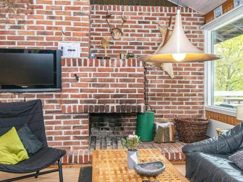 a living room with a brick wall at 6 person holiday home in Knebel in Knebel