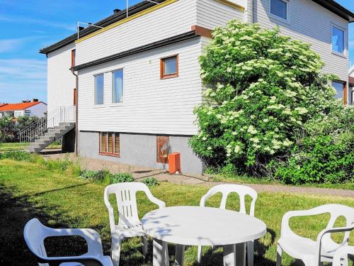 a table and chairs in the yard of a house at 7 person holiday home in SK RHAMN in Skärhamn