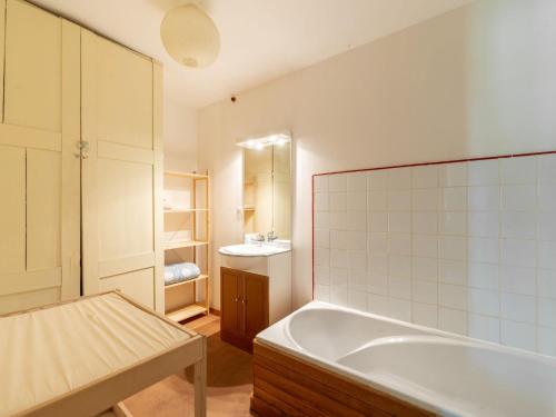 ein Badezimmer mit Badewanne und Waschbecken in der Unterkunft Quaint Holiday Home in Ferce in Fercé