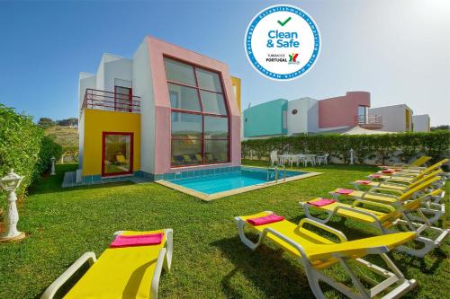 a group of lawn chairs and a swimming pool at Vila Marina -BBQ, pool & garden- by Seareen in Albufeira