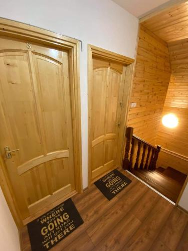 a room with a door and a sign on the floor at Fakanalas Fogadó in Pásztó