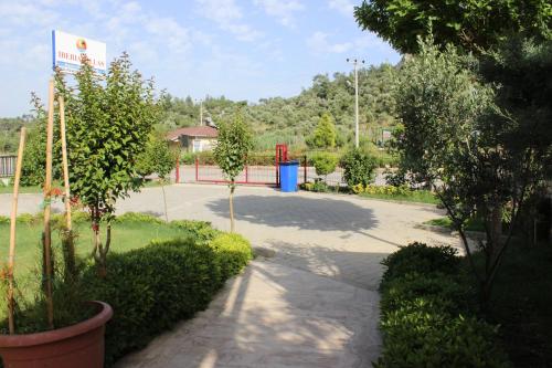 a parking lot with trees and a playground in a park at İberia Villas in Ortaca