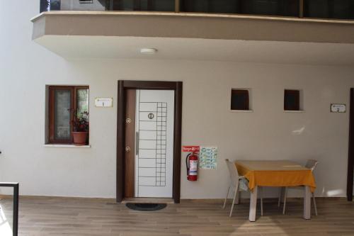 a dining room with a table and a door at İberia Villas in Ortaca