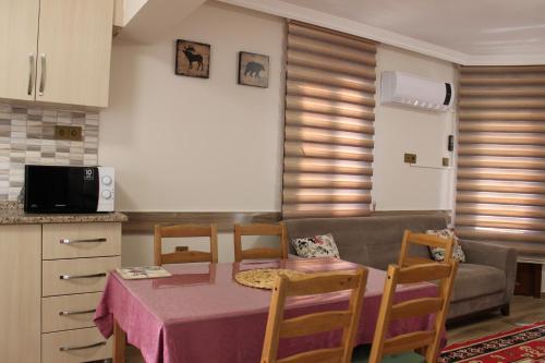a kitchen and living room with a table and a couch at İberia Villas in Ortaca