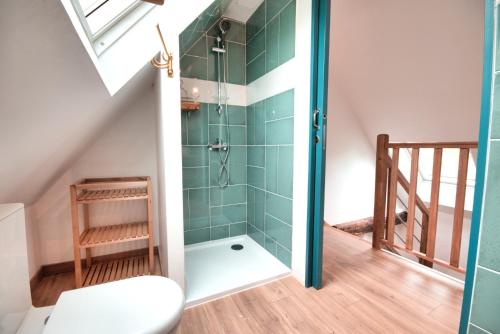 a bathroom with a shower in the attic at Les gites du Lety in Perret