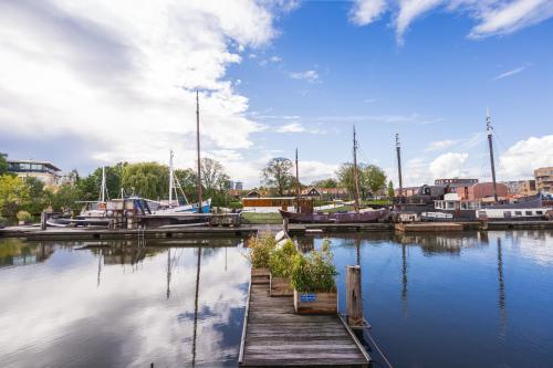 a dock with boats in a marina on the water at Asile Flottant in Amsterdam