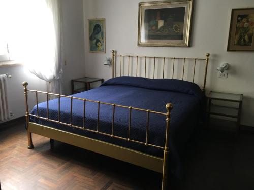 a bedroom with a bed with a blue blanket at Casa Marina in Castiglione della Pescaia