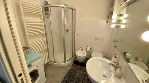 a bathroom with a shower and a sink and a toilet at Casa Anna in Lovere