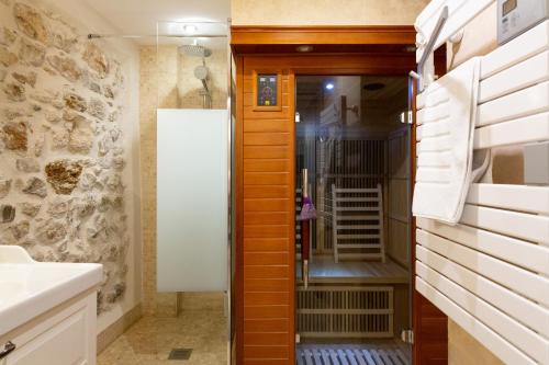 a bathroom with a walk in shower and a sink at MAISON PICASSO in Antibes
