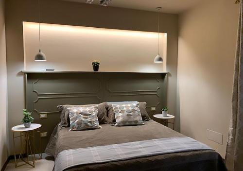 a bedroom with a large bed with two tables at B&B Villa del Sole Relais in Agrigento