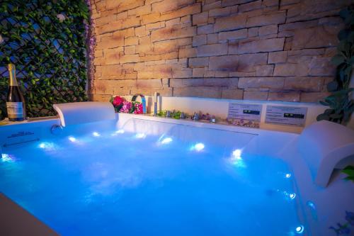 a hot tub in a room with a brick wall at Historia Vitiello: The First Experience Suite in Santa Margherita Ligure
