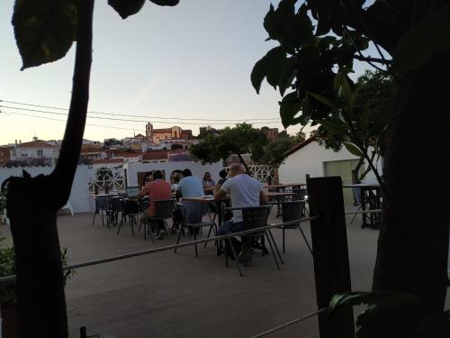 a group of people sitting at tables on a patio at Ponte Romana in Silves