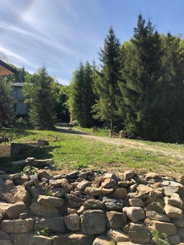 a pile of rocks in a field next to a house at RIVIERA in Lekechi