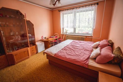 a bedroom with a bed and a window at Privát Ľubica in Fiľakovo