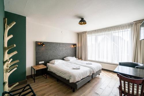Ένα ή περισσότερα κρεβάτια σε δωμάτιο στο Hotel & Eetk'fee de VLiK