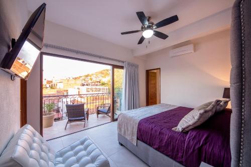 Un dormitorio con una cama y un balcón. en NISE, en Puerto Vallarta