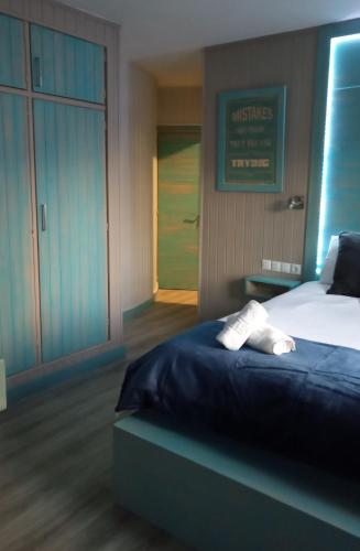 a bedroom with a bed with two white towels on it at Villa Palma in Marbella
