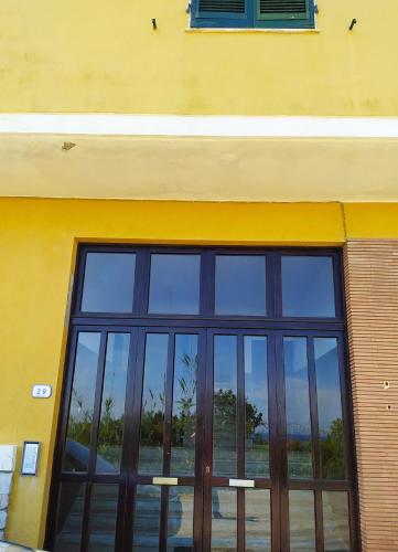 a building with a large glass window on it at Ghiaie sea view in Portoferraio