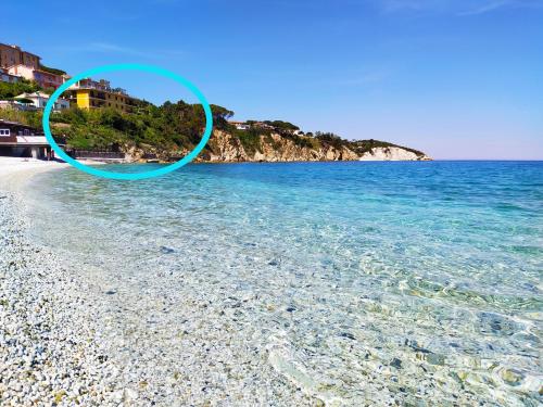 a picture of a beach with a blue circle on it at Ghiaie sea view in Portoferraio